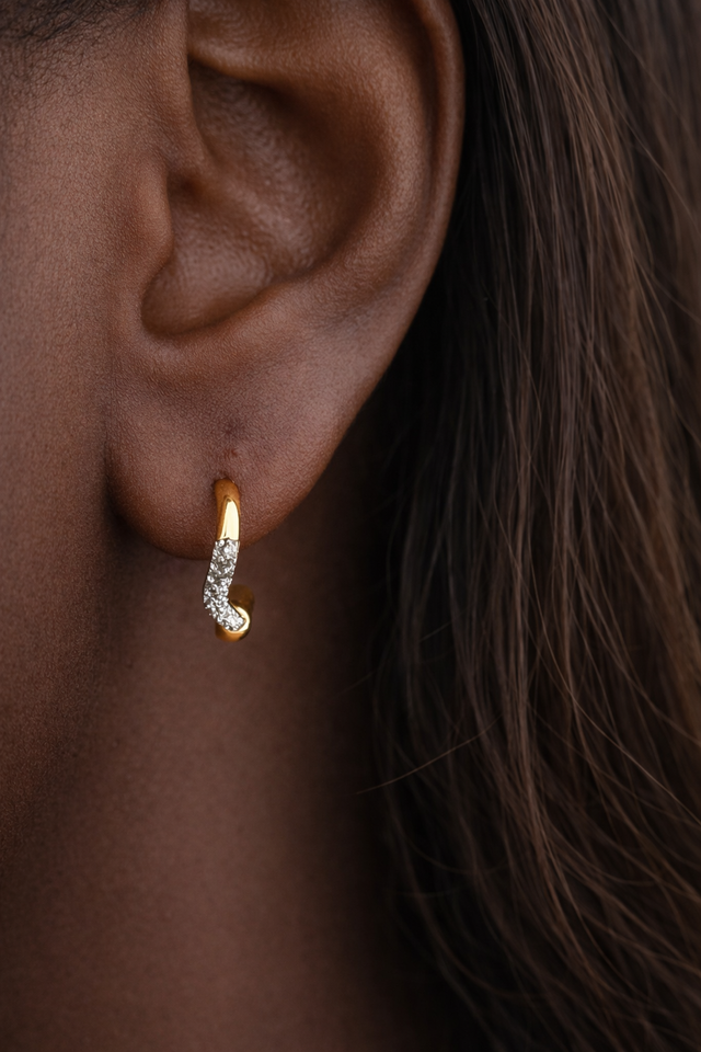 Amara Kyma mixed metal huggie earring worn in first lobe piercing on model