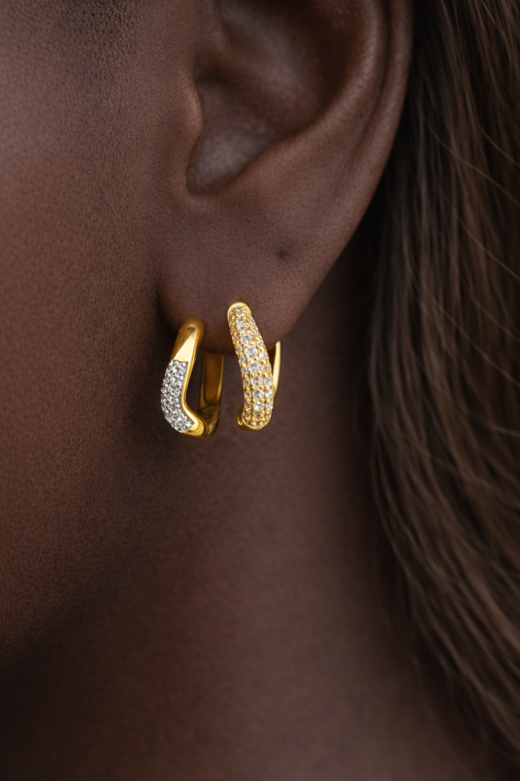 Amara Kyma two tone huggie styled with Aurora Kyma sister huggie in stacked ear look