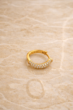 Flatlay of Aurora Kyma 10mm gold plated sterling silver huggie earring