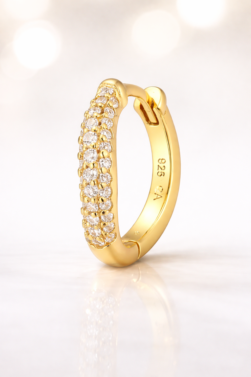 Aurora Kyma 10mm gold huggie earring studio image with pavé front detail