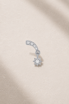 Celestial-inspired silver stud earring with white CZ stones on neutral stone background