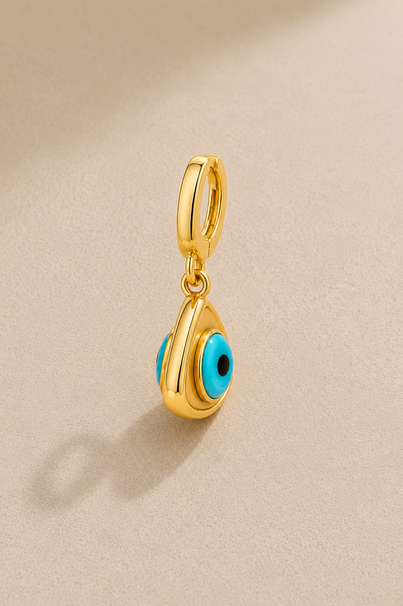 Side view of gold evil eye hook charm showing double-sided turquoise eye detail