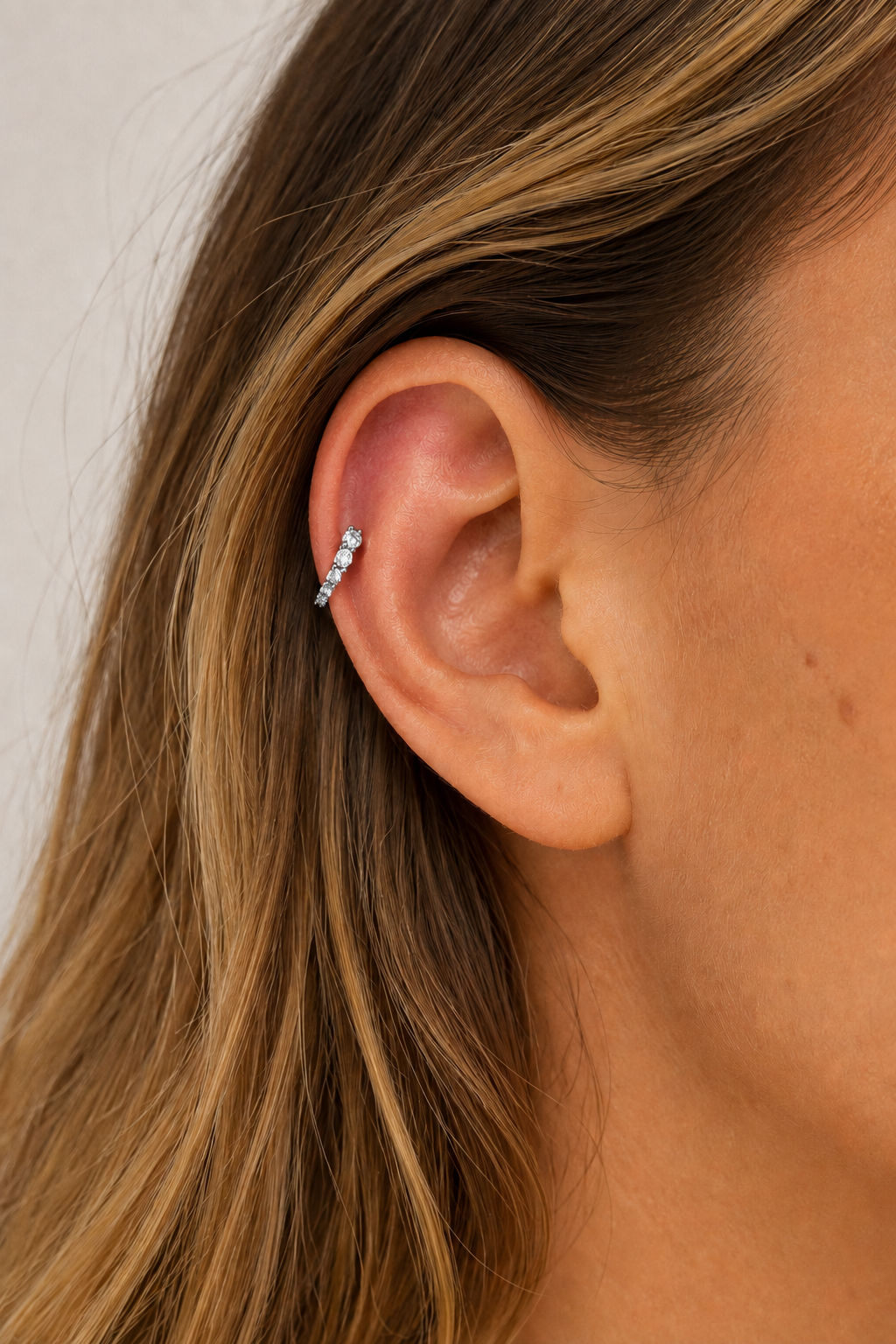 Gala Reverse Silver Huggie Earring 6.5mm worn on ear