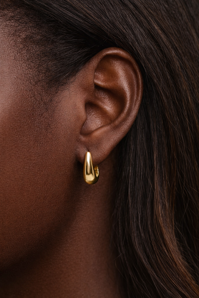 gold hoop earrings worn on ear everyday styling classic look