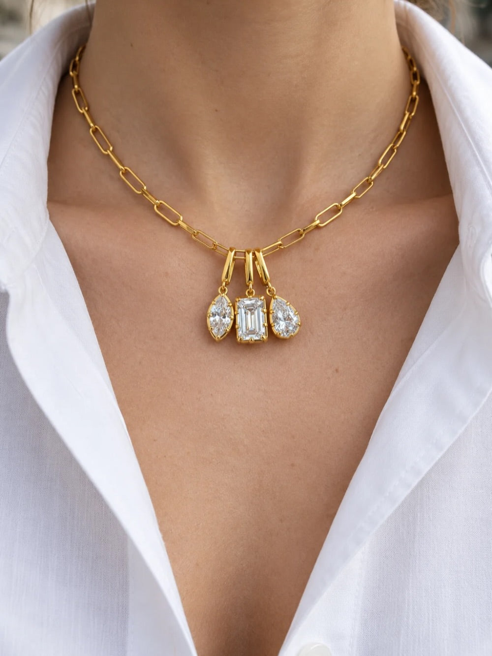 40 cm gold chain by Galleria Armadoro styled with three Vittoria charms, including an emerald-cut centre charm and two marquise charms.