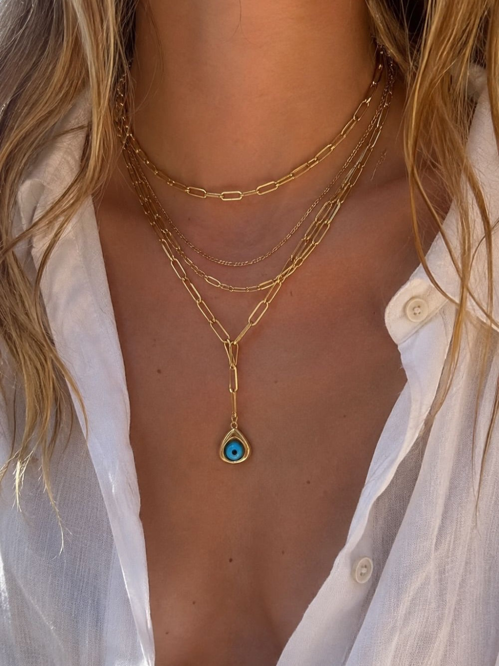 Layered gold necklace look by Galleria Armadoro with two Large Link Gold Chains worn at 35 cm and 40 cm, fine gold chains and an evil eye charm.