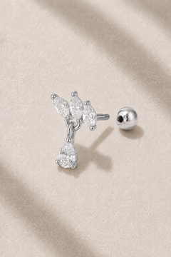 Silver floral ball screw piercing stud with white CZ stones on neutral stone background