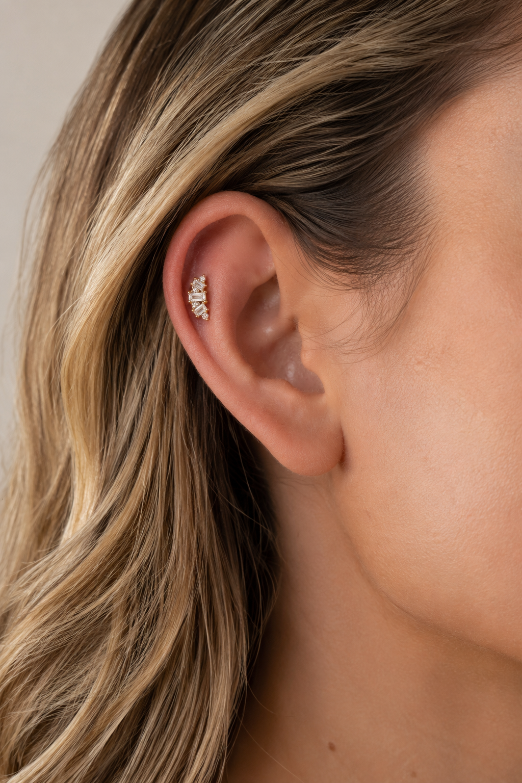 Lumière Gold Ball Screw Stud Earring worn on ear with bright white CZ sparkle