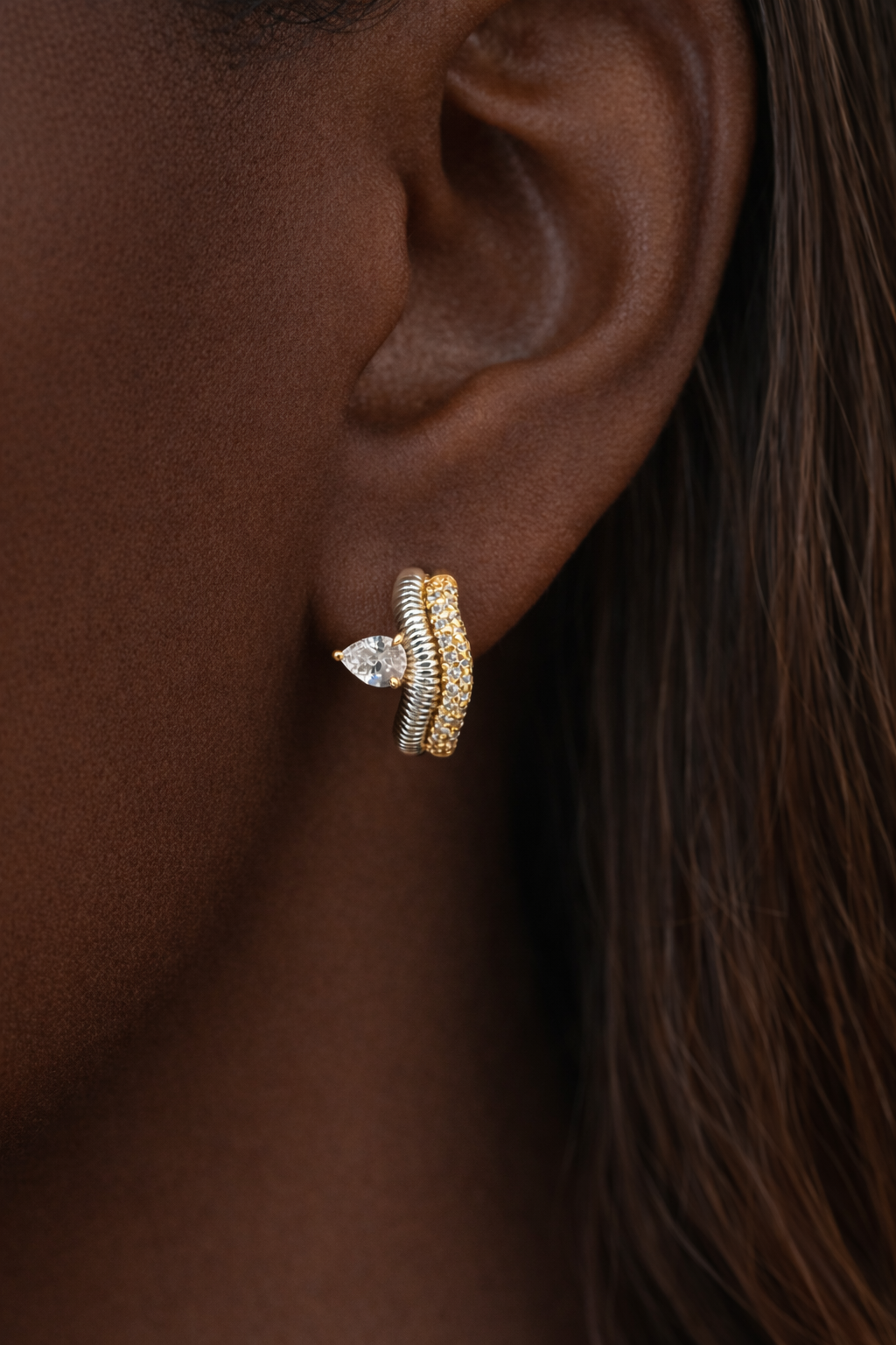 Maura mixed metal huggie earring worn on ear first lobe piercing