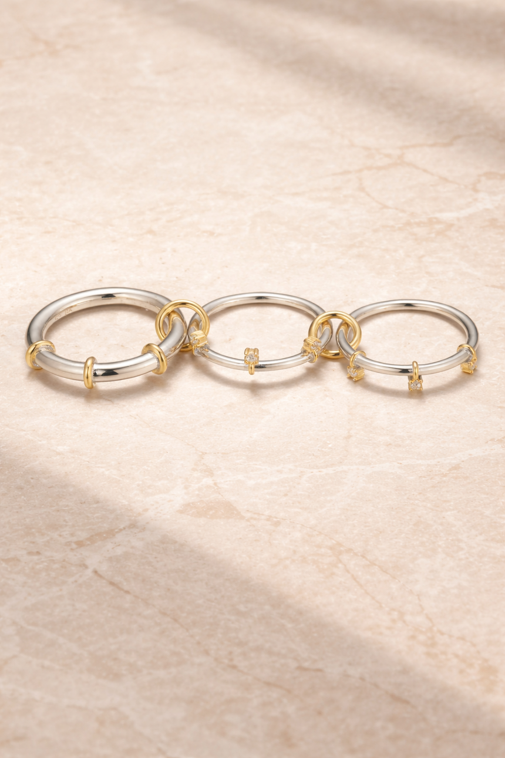 onnected band ring with polished silver loops and gold accents