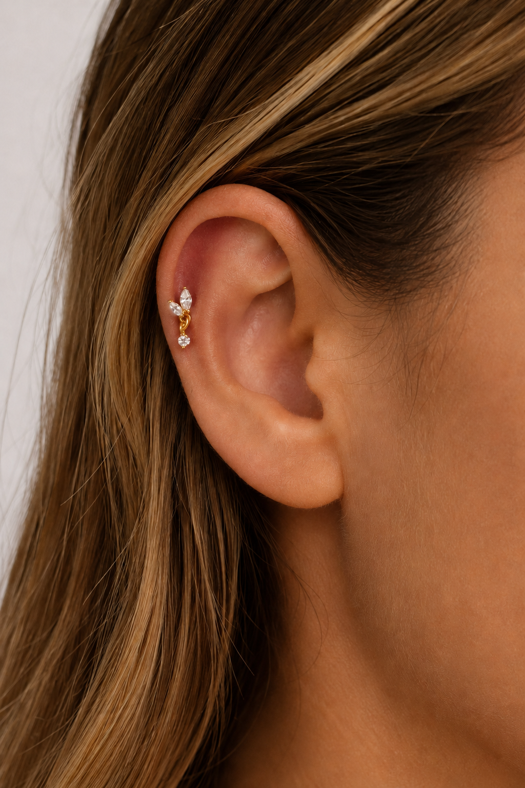 Papillon Gold Ball Screw Stud Earring worn on ear with delicate white CZ sparkle