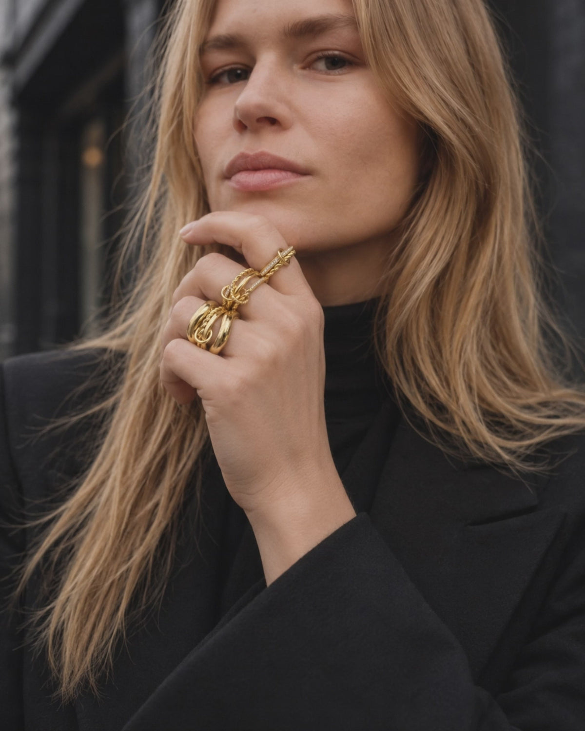 All-gold ring stack by Galleria Armadoro styled with a total-black outfit for a polished sculptural jewellery look.