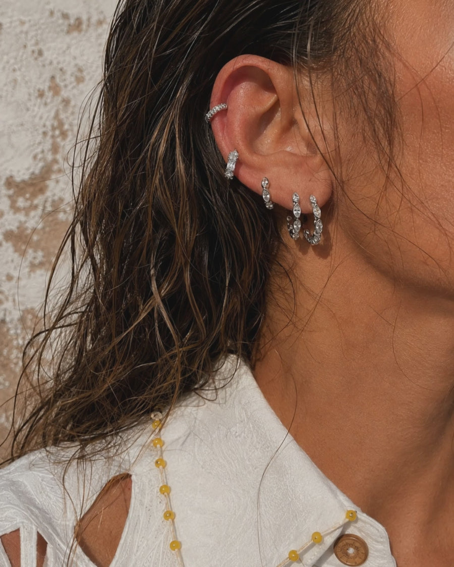 Silver marquise ear stack by Galleria Armadoro featuring Tasha earrings graduated from larger hoops at the lobe to smaller details higher on the ear.