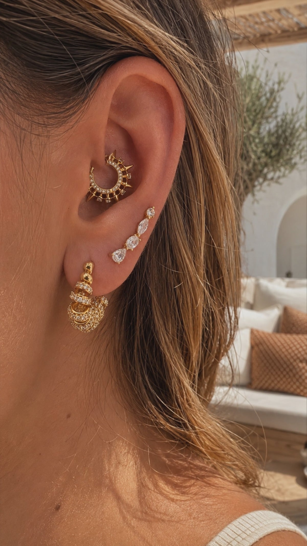 Gold daith ear stack styled by Galleria Armadoro with a sculptural Spina daith earring, marquise details and layered pavé lobe earrings.