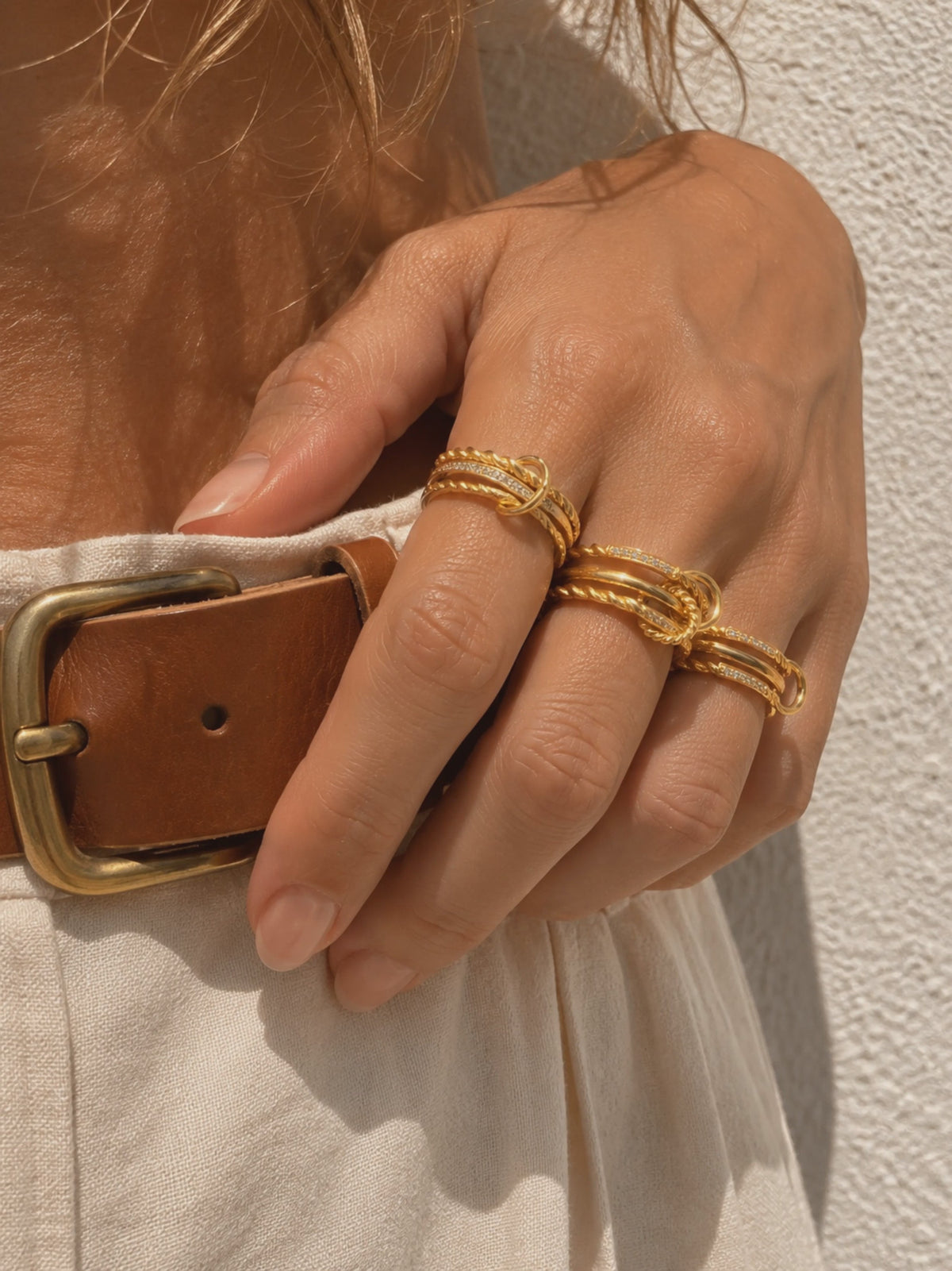 Gold ring stack styled by Galleria Armadoro with sculptural rope rings, polished gold bands and pavé details.