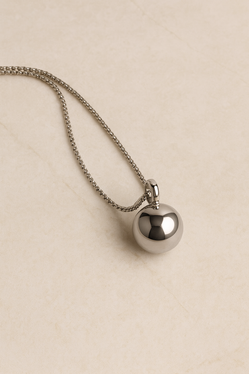Close view of Riva silver sphere pendant with mirror-polish on special-design chain