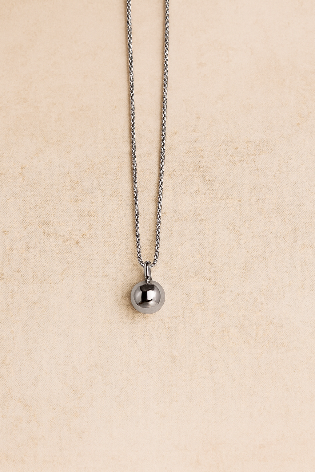 Riva silver sphere pendant hanging on special-design chain, rhodium plated brass, front view