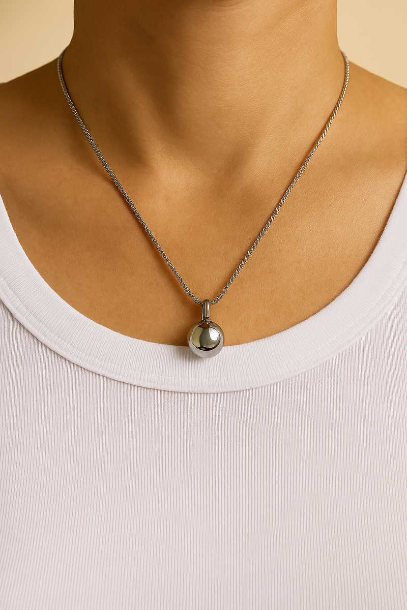 Riva sphere pendant necklace in white rhodium plated silver tone worn on neck, special-design chain