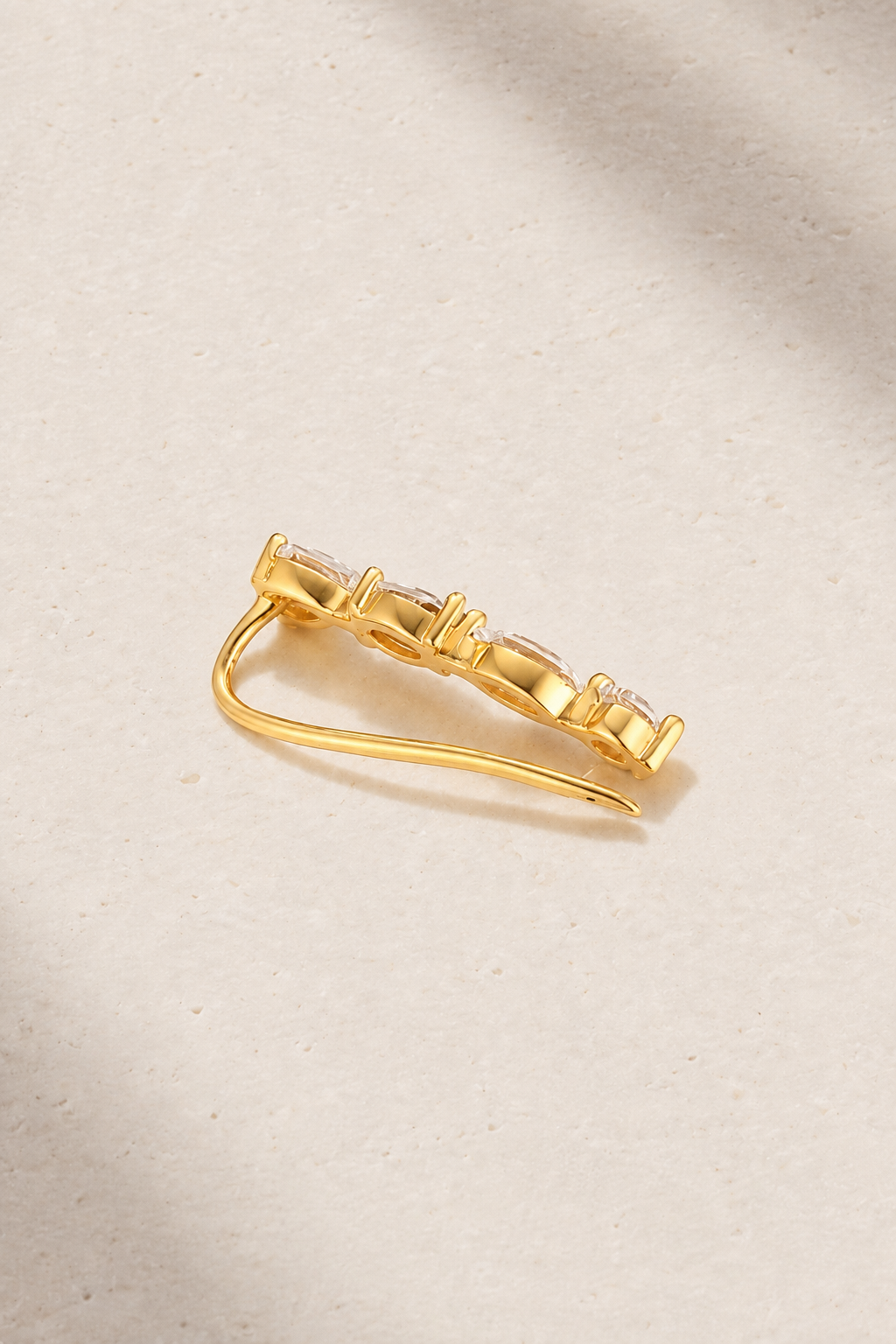 Close-up detail of Riviera Gold Ear Climber with pear, oval, marquise and round CZ stones