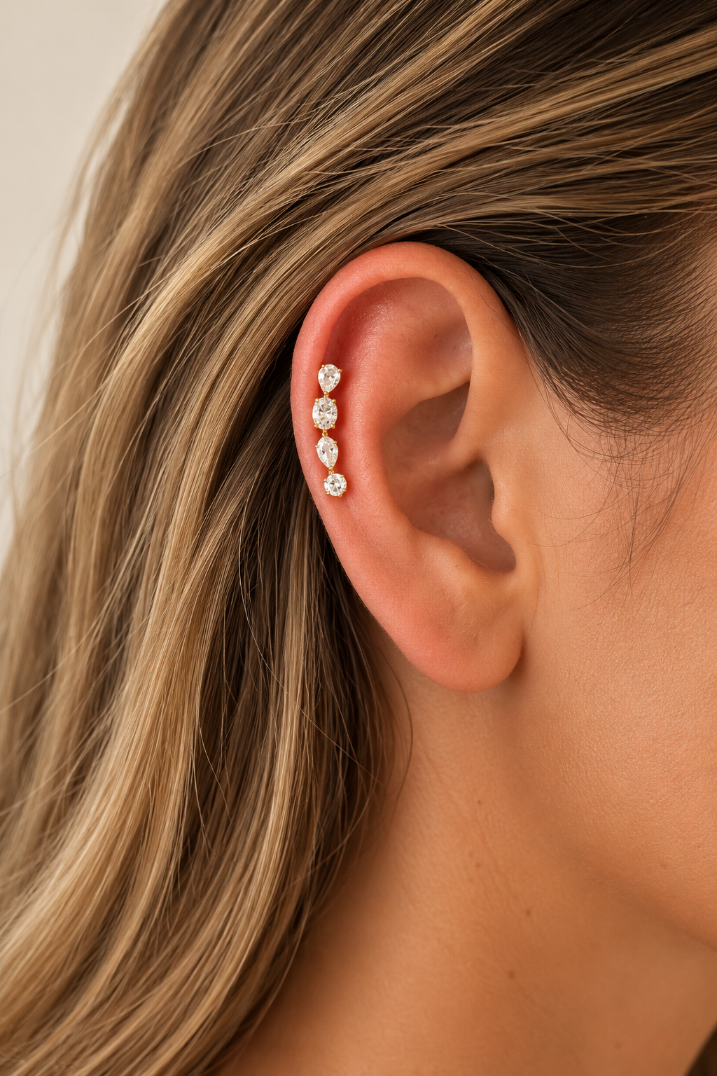 Close-up detail of Riviera Gold Ear Climber with pear, oval, marquise and round CZ stones