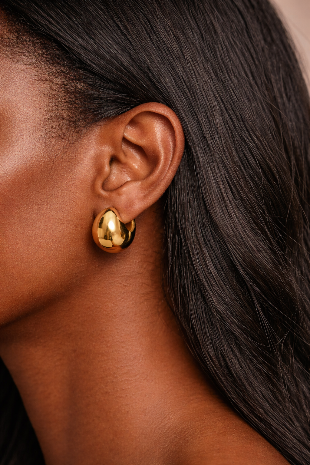 small gold hoop earrings worn on ear everyday styling
