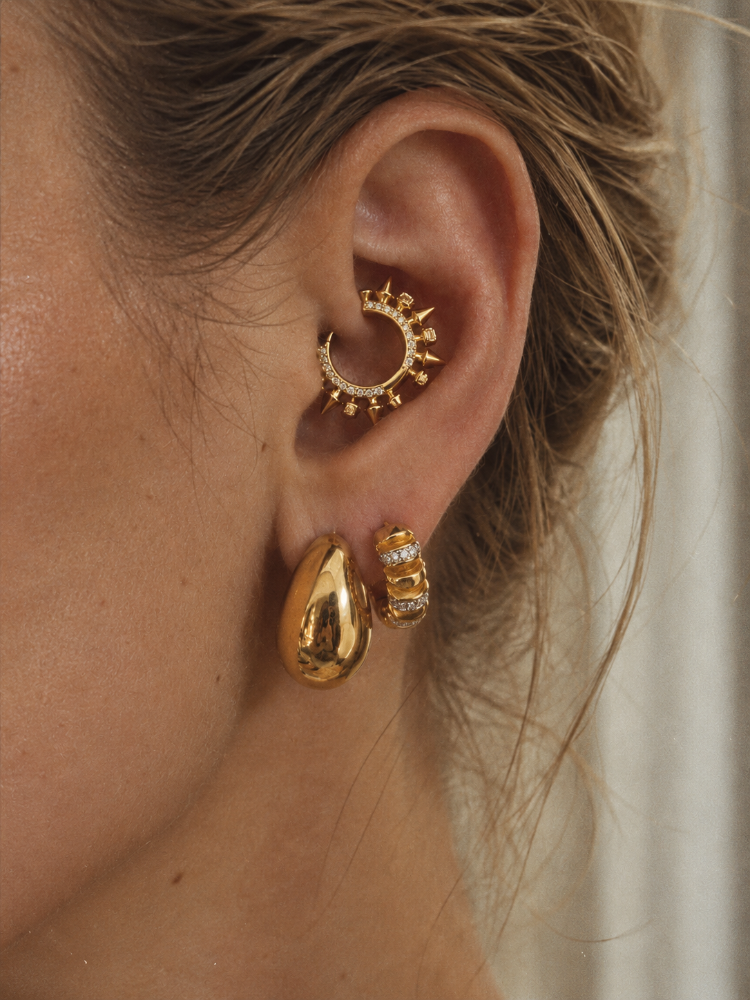 Bold gold ear stack by Galleria Armadoro featuring Sophie Gold Hoops, Noor Gold Huggie and Spina Gold Huggie with sculptural and pavé details.
