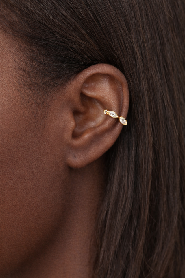 Tasha marquise gold vermeil ear cuff worn on ear featuring three marquise-cut stones in a modern cartilage ear stack