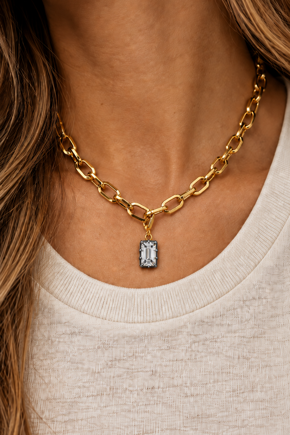 Model wearing the Vittoria Emerald Cut black rhodium and gold hook charm on the Cara chunky gold plated chain necklace