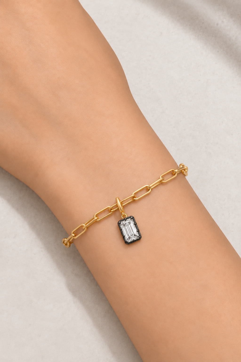 Vittoria Emerald Cut black rhodium and gold hook charm worn on the gold Large Link bracelet