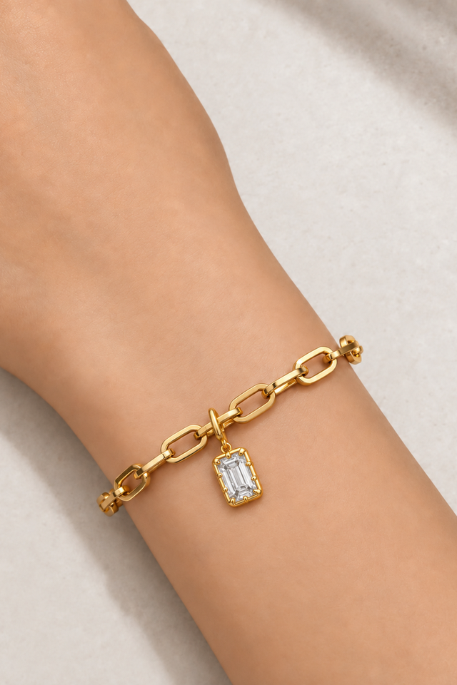 Model wearing the Cara gold plated bracelet with Vittoria Emerald Cut gold hook charm