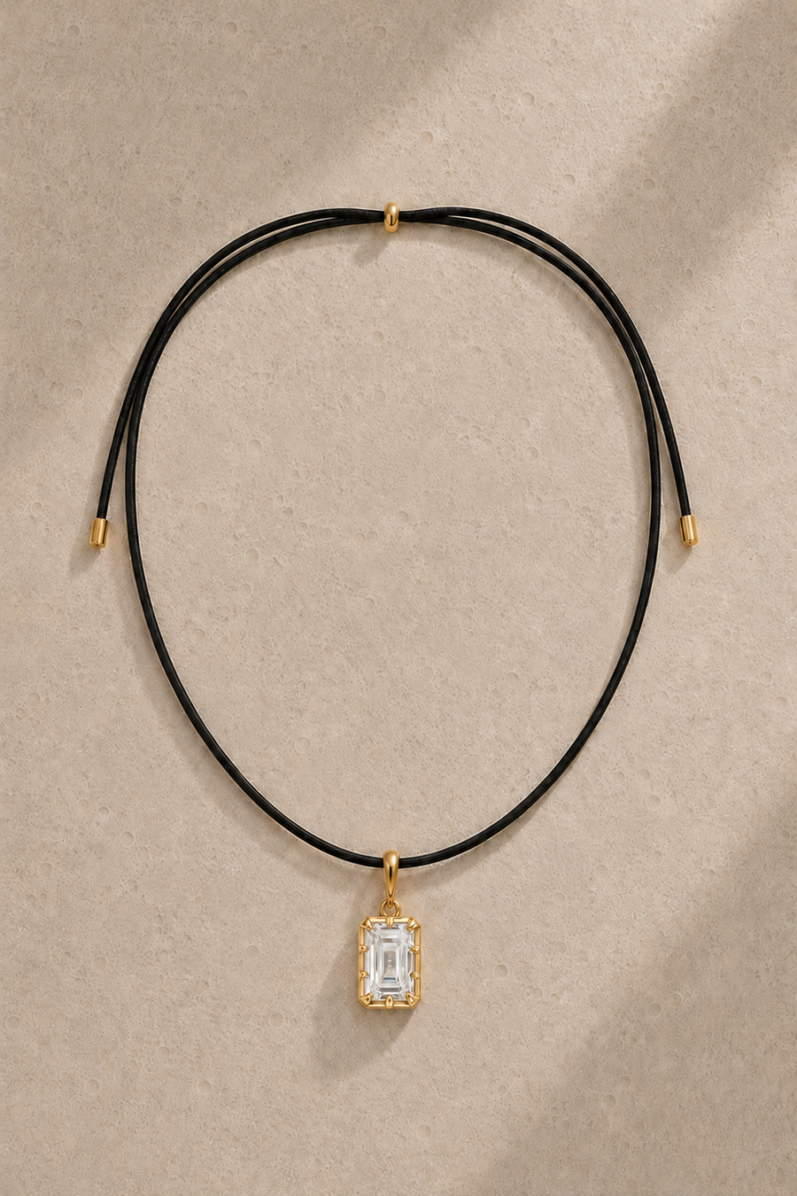 Adjustable black cord necklace with Vittoria emerald-cut 24ct gold plated hook charm – full view