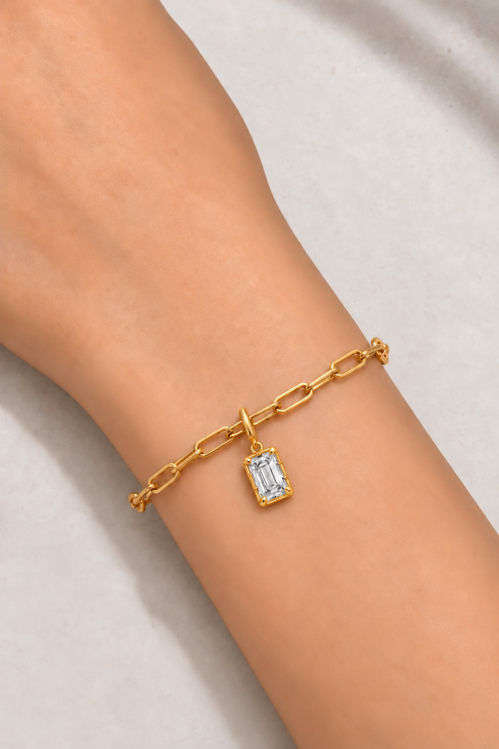 Vittoria Emerald Cut gold hook charm worn on the gold Large Link bracelet