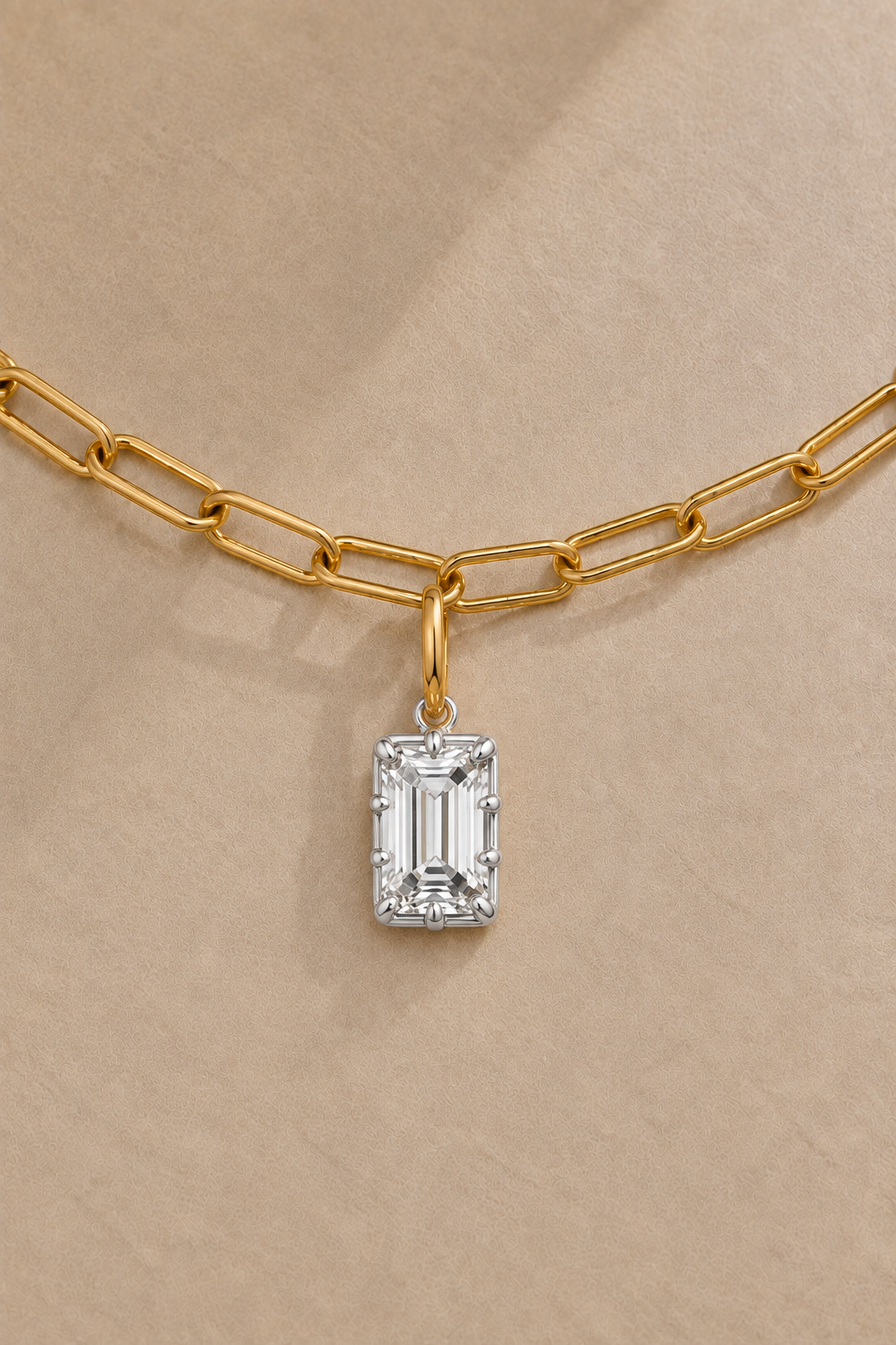 Close-up of Vittoria Emerald Cut white rhodium and gold hook charm on the gold Large Link chain