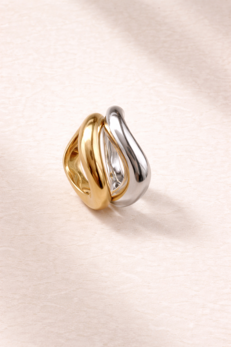 Gold vermeil and sterling silver Kyma wave rings styled side by side on a clean background